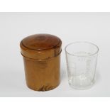 Fruitwood medicine jar and cover containing a glass beaker with teaspoon and tablespoon markers 8cm