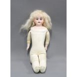 Early 20th century bisque head doll with kid leather body and limbs 33.5cm
