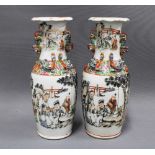A pair of Chinese Canton vases with dragons and temple lions, painted with scholar and other