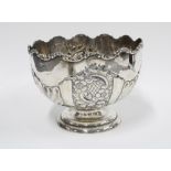 Edwardian silver pedestal punch bowl, half-fluted and chased with flowers and scrolling foliage,