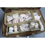 Collection of bisque dolls heads, etc, contained within a vintage brown leather case (a lot)