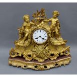 French gilt metal figural mantle clock, with a circular dial with roman numerals within a