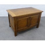 Light oak coffer of traditional design with a dentil frieze over a double panelled front, hinged lid