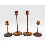 Two pairs of /art Nouveau pokerwork candlesticks, tallest 25cm (4)