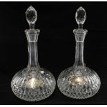 A pair of glass globe and shaft decanters and stoppers together with Port & Sherry decanter labels