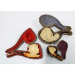 Three antique Meerschaum pipes, with cases, the miniature pipe and one other with damage to amber