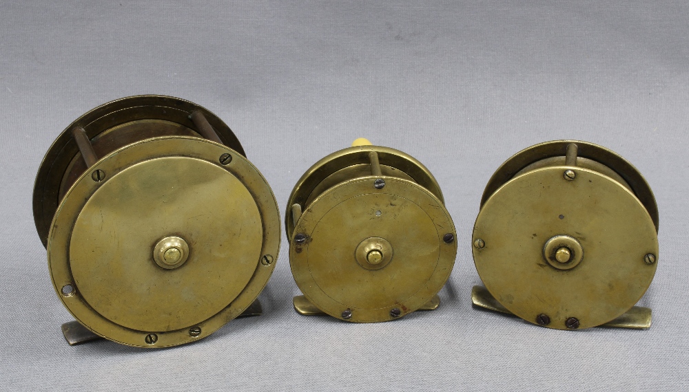 Large brass salmon fishing reel and two smaller brass trout fishing reels, one signed to the - Image 2 of 2