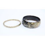 9ct gold stiff hinged bangle and a modern bangle with dragon pattern (2)