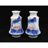 A pair of Japanese porcelain vases , white glazed with blue an red flowers, 14cm (2)