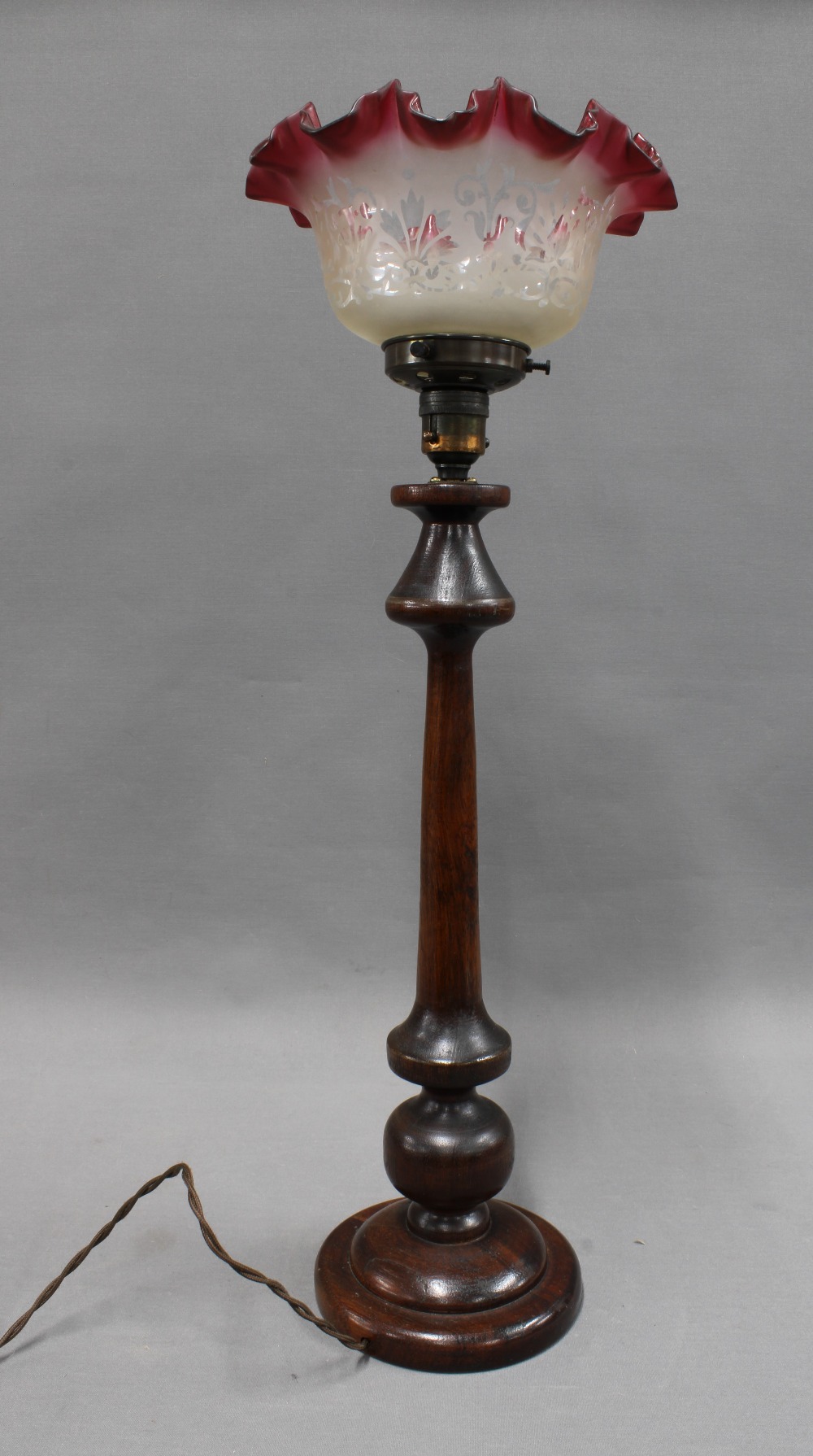 Mahogany table lamp with red frilled glass shade. 61cm.