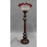 Mahogany table lamp with red frilled glass shade. 61cm.
