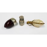 Three scent bottles to include a shell and brass mounted bottle, cranberry glass and white metal