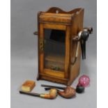 An Edwardian oak and glass pipe cabinet, 32cm, together with a collection of briar pipes to