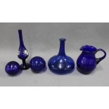 A collection of Bristol blue glass to include a jug, flat bottomed bottle, two glass witches balls