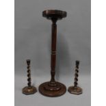 A pair of Edwardian oak barley twist candlesticks and an oak stand with circular dished top, 61cm