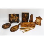 A collection of Art Nouveau pokerwork items to include photograph frames, glove stretchers and a