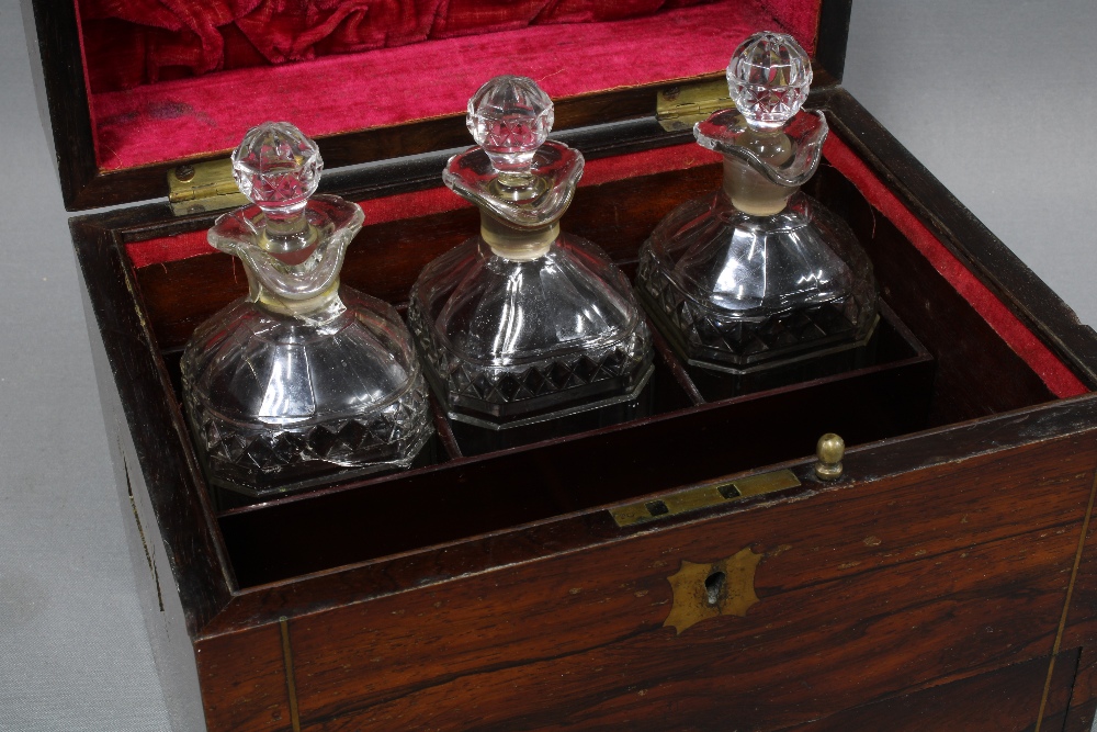 19th century rosewood and brass inlaid decanter box, the hinged lid opening to reveal a set of three - Image 2 of 4