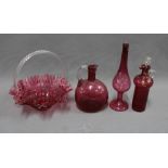 A collection of cranberry glass to include a posy basket, decanter and stopper, vase, etc, tallest