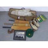 A vintage collection of cricket related items, includes three bats, a ball, shoes and books,