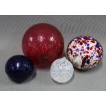 A collection of coloured glass witches balls, to include cranberry glass & Bristol blue, largest