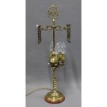Brass table lamp base with four arms on lion supports, barley twist column and circular wooden base,