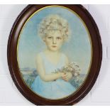 Early 20th century print of a young girl with curly blonde hair, in an oval oak frame, under