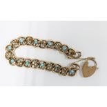 9ct gold bracelet set with seed pearls and turquoise with a heart padlock