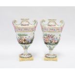 Pair of Naples capodimonte urn vases moulded in relief and painted in colours depicting classical