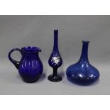 A collection of Bristol blue glass to include a jug, flat bottomed bottle, and a Bohemian and enamel