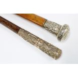 Chinese malacca walking cane with embossed white metal handle and another with Thai style metal