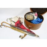 A vintage hat box containing as collection of costume jewellery, opera glasses, gloves, evening