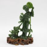 Spinach green jade carving of a woman with a fan and flowers, on wooden stand, 22cm.