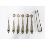 Eastern white metal filigree spoons, fork and sugar tongs, (7)