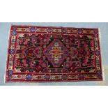 Handwoven Eastern rug, central medallion with serrated edge, multiple borders 200 x 114cm