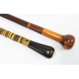 An early 20th century banded horn walking cane, brass ferule end, 84cm and a rosewood and specimen