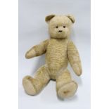 Vintage blonde teddy bear with bead eyes and jointed limbs, 80cm long