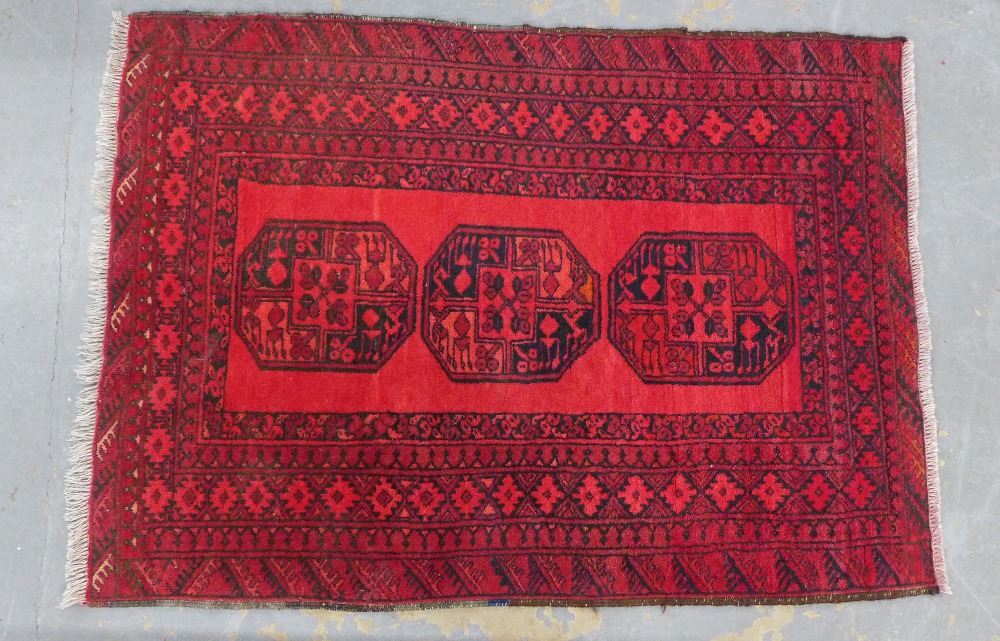 Afghan rug, red field with three guls within multiple borders, 145 x 106cm