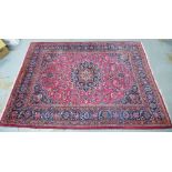 Large Persian carpet with a central flowerhead medallion and allover foliate field, 250 x 350cm