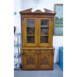 Late 19th / early 20th century oak bookcase cabinet with a broken swan neck top over a pair of