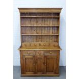 Large pine kitchen dresser, with stepped cornice over shelved plate back with four short spice
