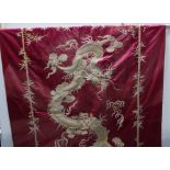Large Chinese silk panel embroidered with a dragon chasing the pearl of wisdom within a border of