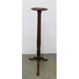 Mahogany torchere stand, the circular dished top on a reeded column and tripod base. 138 x 57cm.