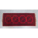 Small Afghan prayer rug with a red field and four medallions. 150 x 57cm.