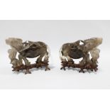A pair of rock crystal carved water buffalo, modelled standing on associated hardwood bases 20cm