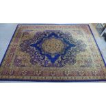 Large Eastern carpet, blue field with central flowerhead medallion and multiple borders, 260 x