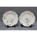 Two floral patterned faience plates with scalloped edge (2)