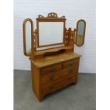 Art nouveau mahogany dressing table with stylised triple mirror and pair of jewel drawers over a