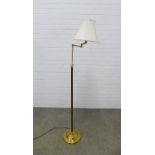 Adjustable brass standard lamp with rise and fall action, complete with shade. 160cm high.