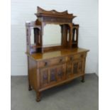 Art Nouveau oak sideboard, with a ledgeback top above a dentil cornice with carved frieze and triple
