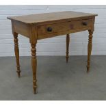Pine desk with rounded rectangular top above a frieze drawer, on ring turned legs, 76 x 93 x 52cm.